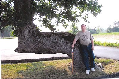 Ken Ward Kenneth Ward standing beside one of the marker trees located near Haleyville